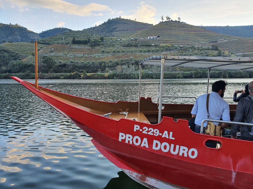 A private wooden boat on the Douro river bends from Pinhao
